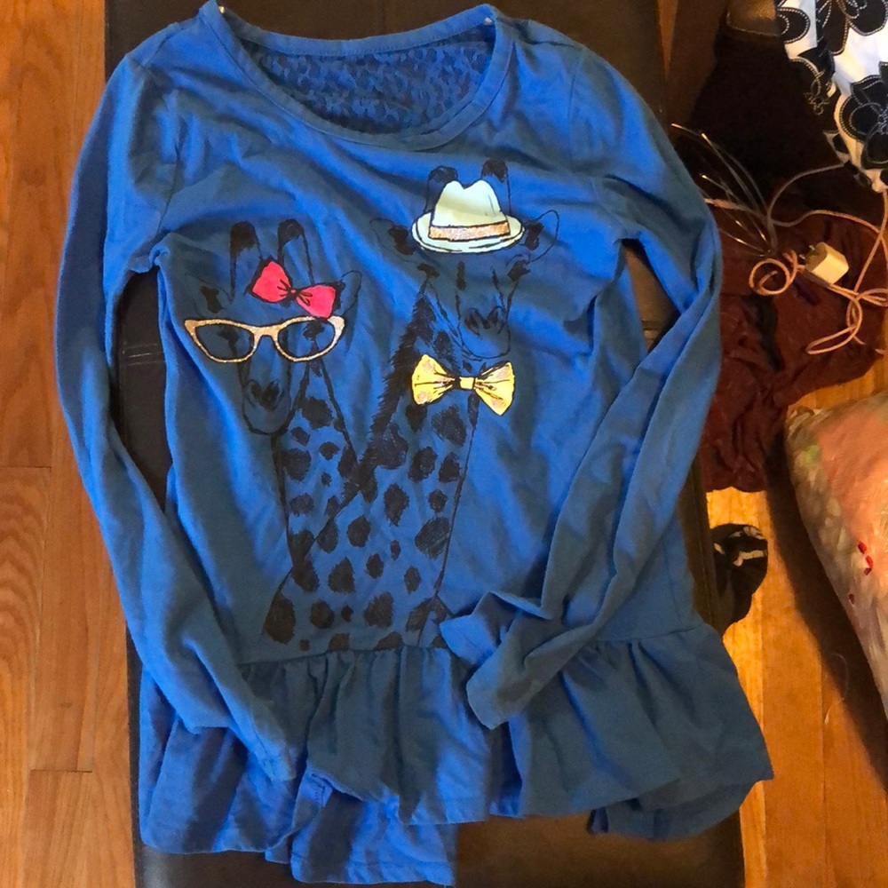 A nice blue long sleeve shirt with a giraffe
